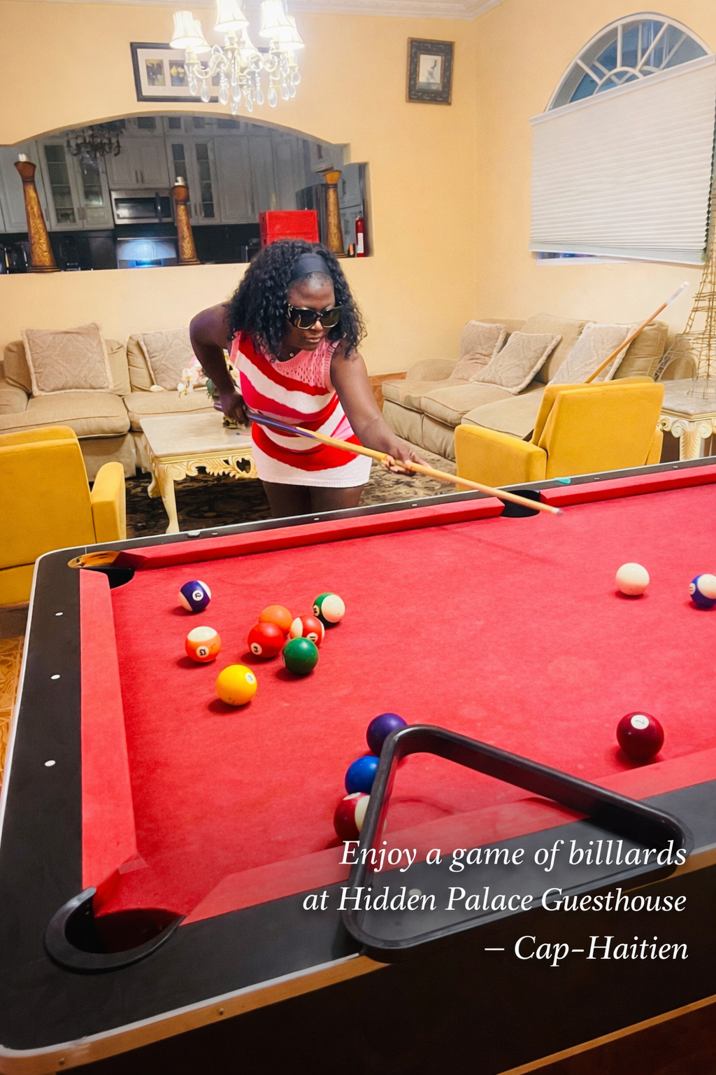Indoor entertainment lounge with pool table at Hidden Palace Cap Haitien